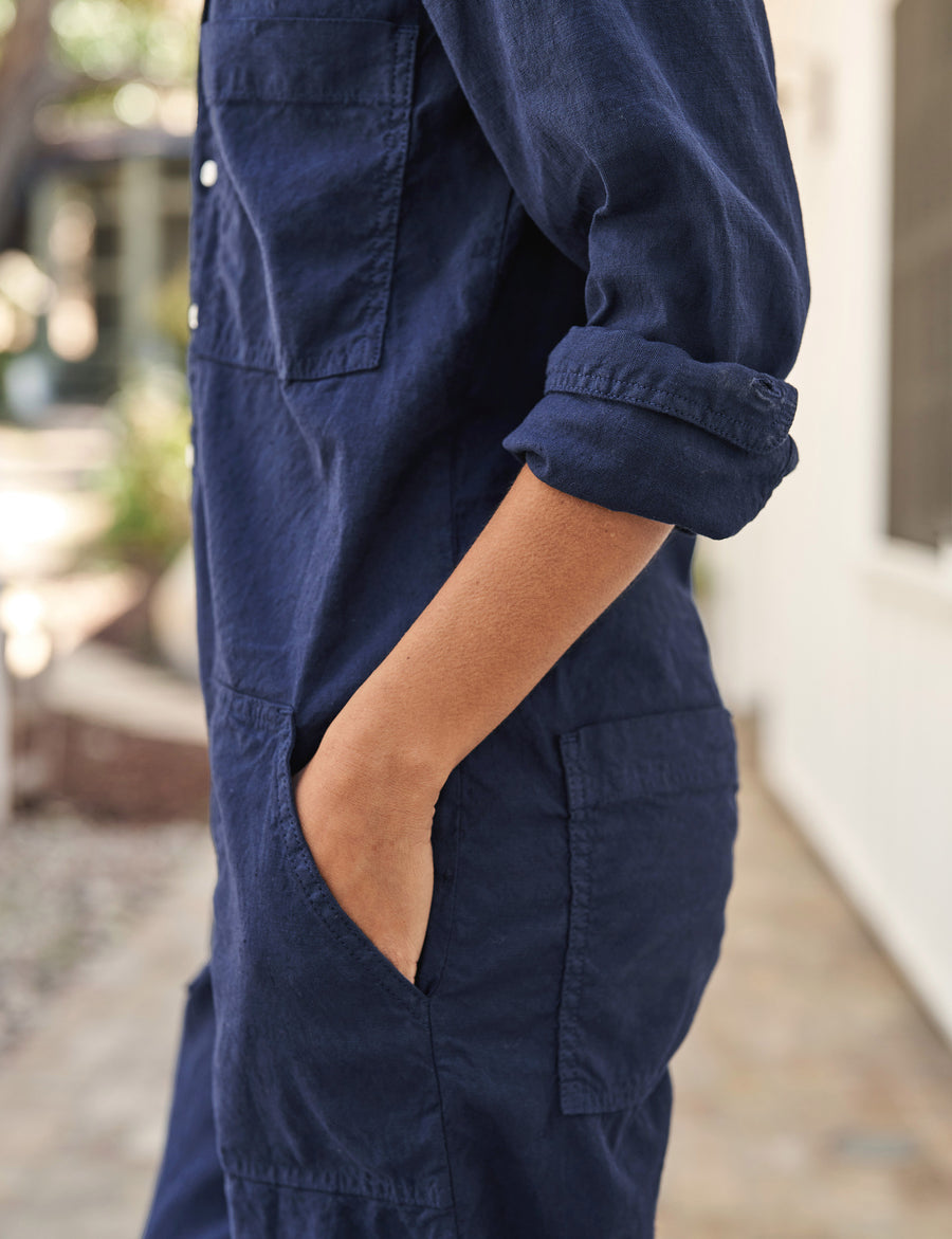 Detail of rolled up sleeve and front pocket on person wearing Navy Frank & Eileen Northern Ireland Jumpsuit in Italian Performance Linen