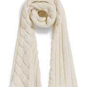 An off-white cable-knit scarf with a twisted center, styled in a loop on a clean white background.