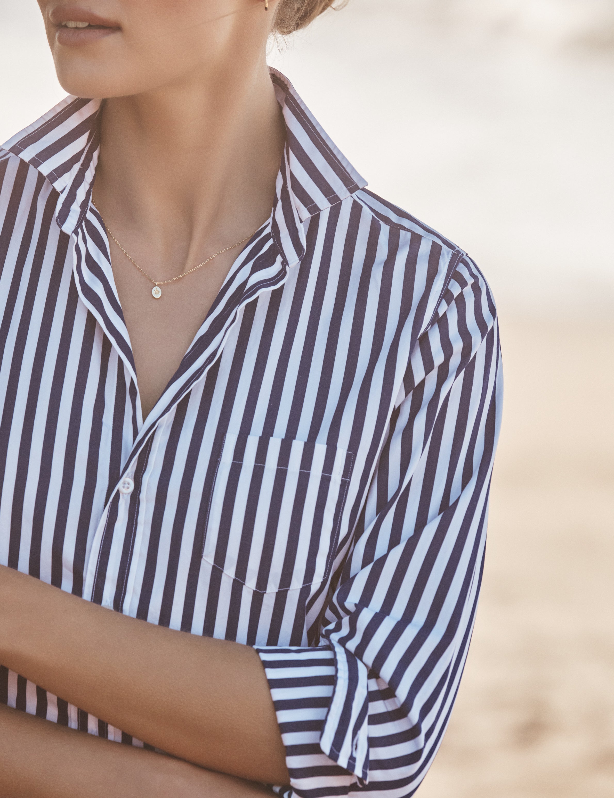 Person wearing a striped shirt with a blurred background, view 3