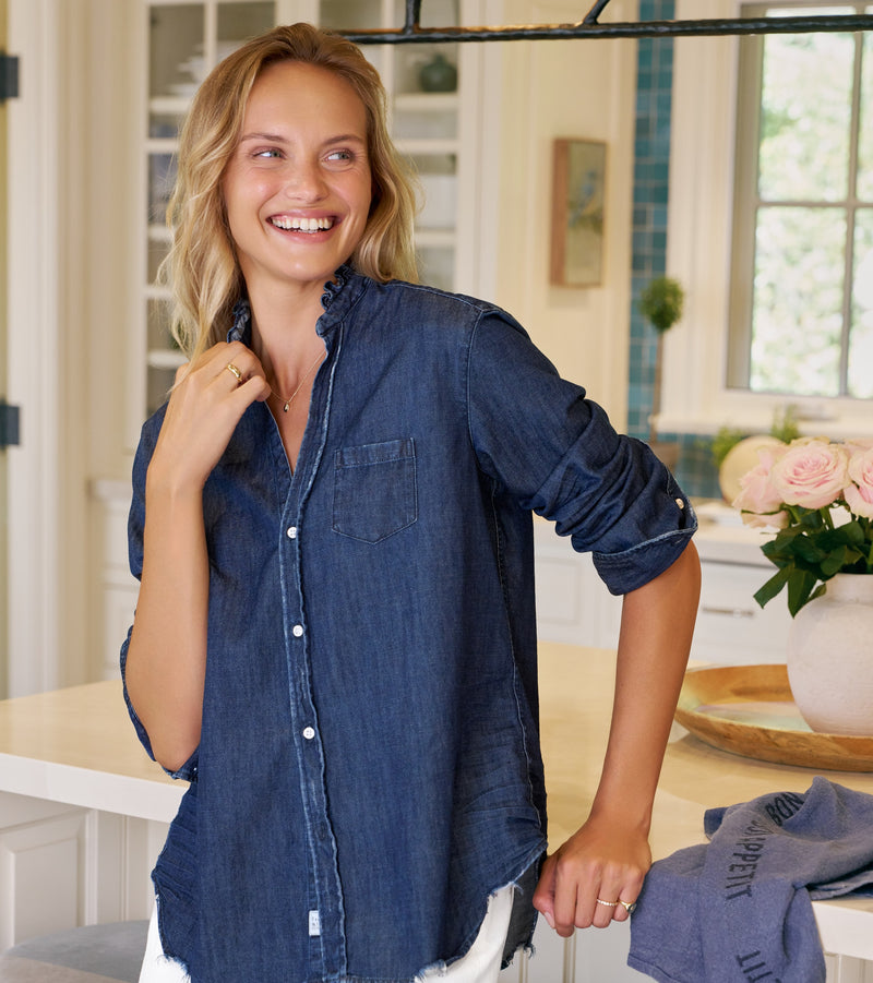 Woman wearing a blue denim shirt in a kitchen setting