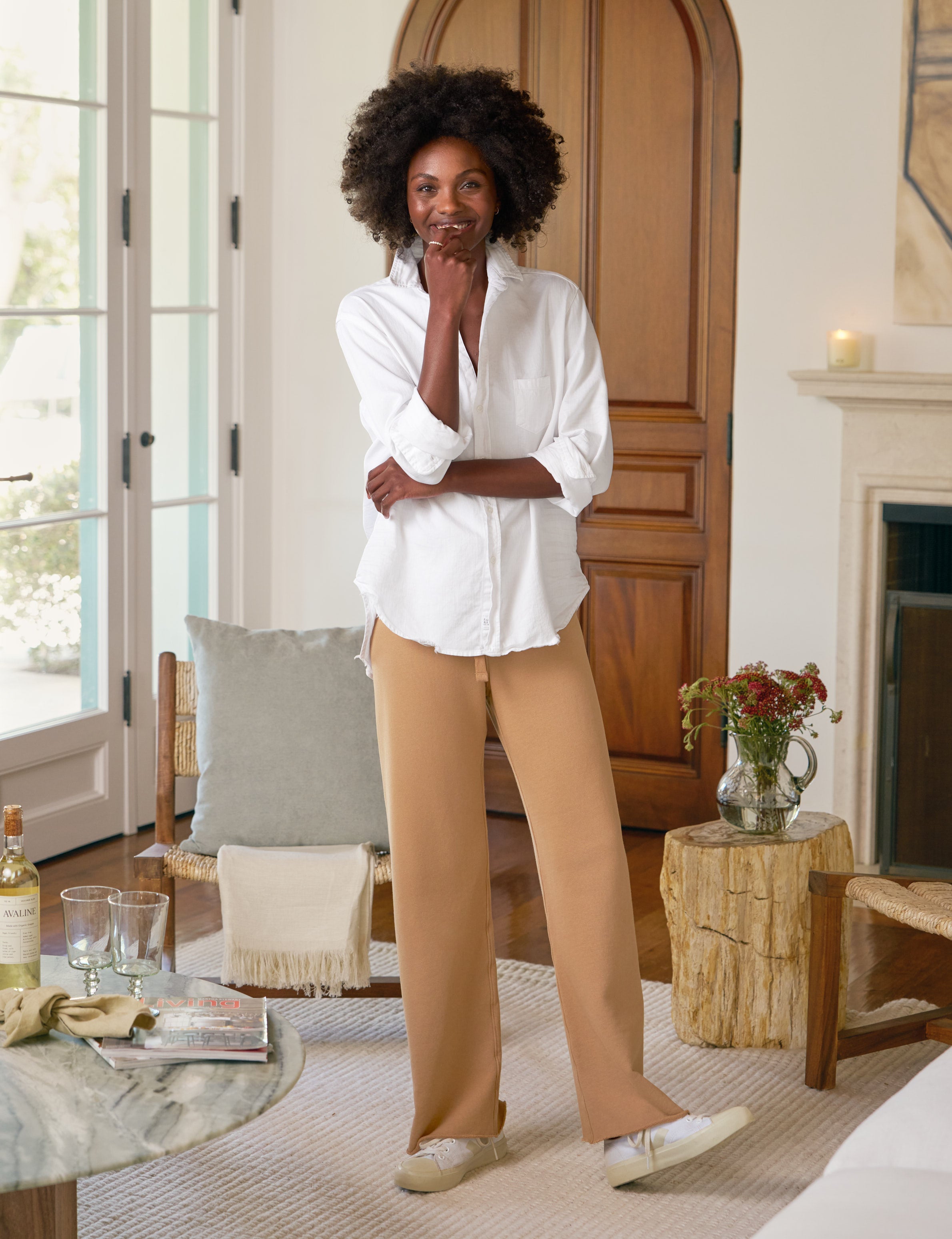 Woman standing in a living room with a neutral color palette
