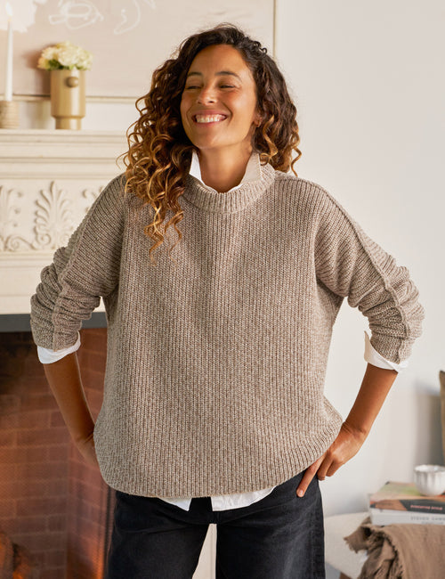 Woman wearing a beige sweater in a cozy indoor setting, view 4