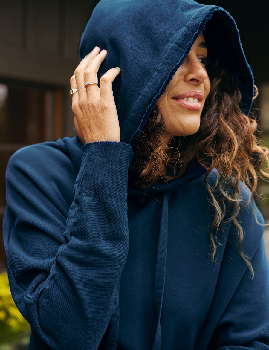 Detail of hood and sleeve on person wearing Blue Frank & Eileen Kane Capelet Hoodie in Triple Fleece