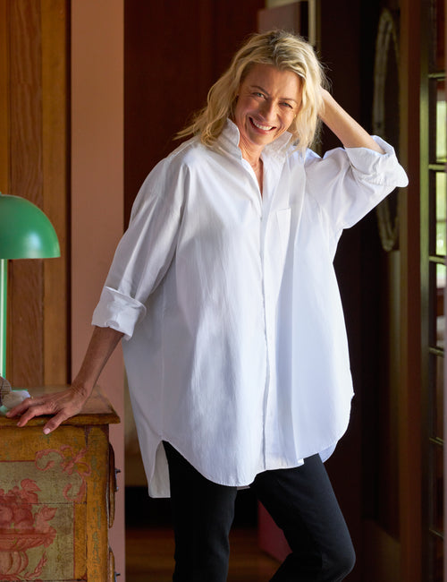 Woman wearing a white shirt in an indoor setting, front view