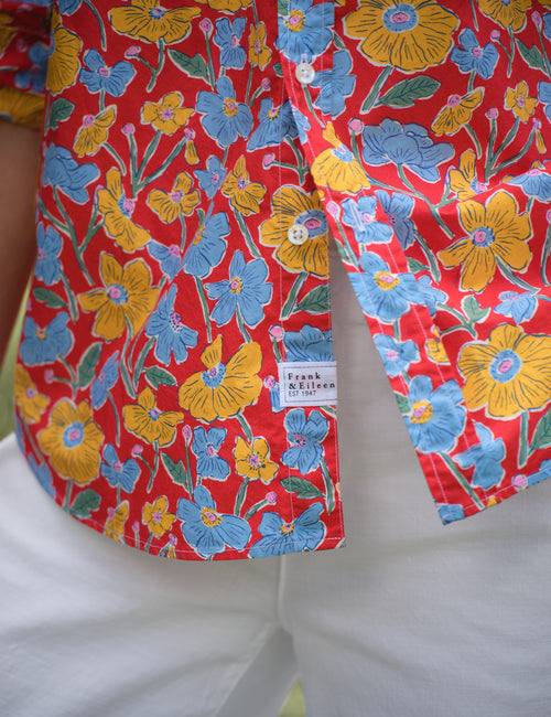 Colorful floral-patterned shirt with a brand label on a white background, alternate view