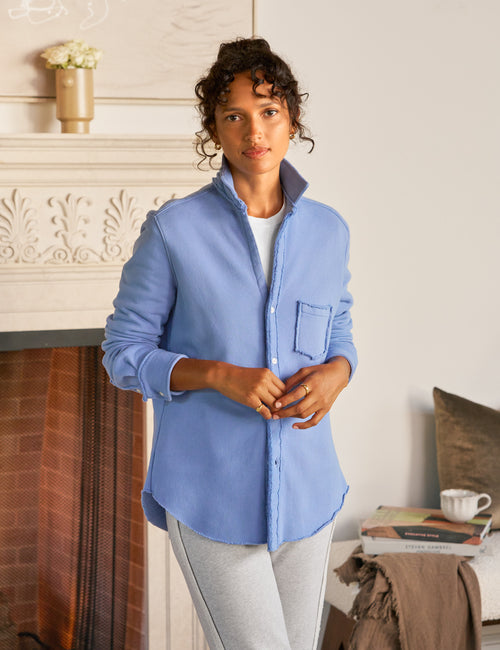 Woman wearing a blue shirt in a home setting, front view