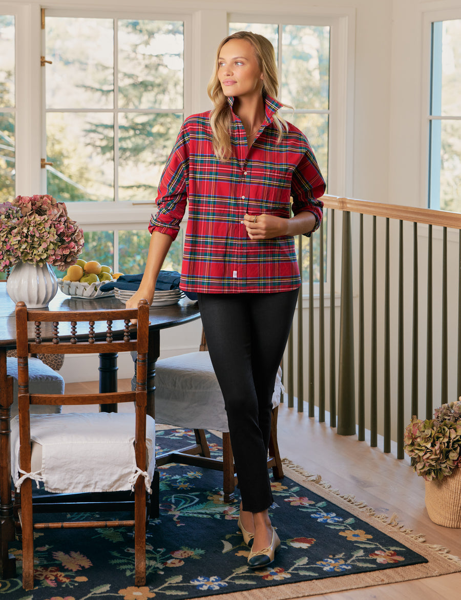 Woman wearing a red plaid shirt in a home setting