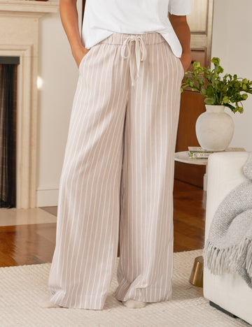 Person wearing beige striped pants in a living room setting