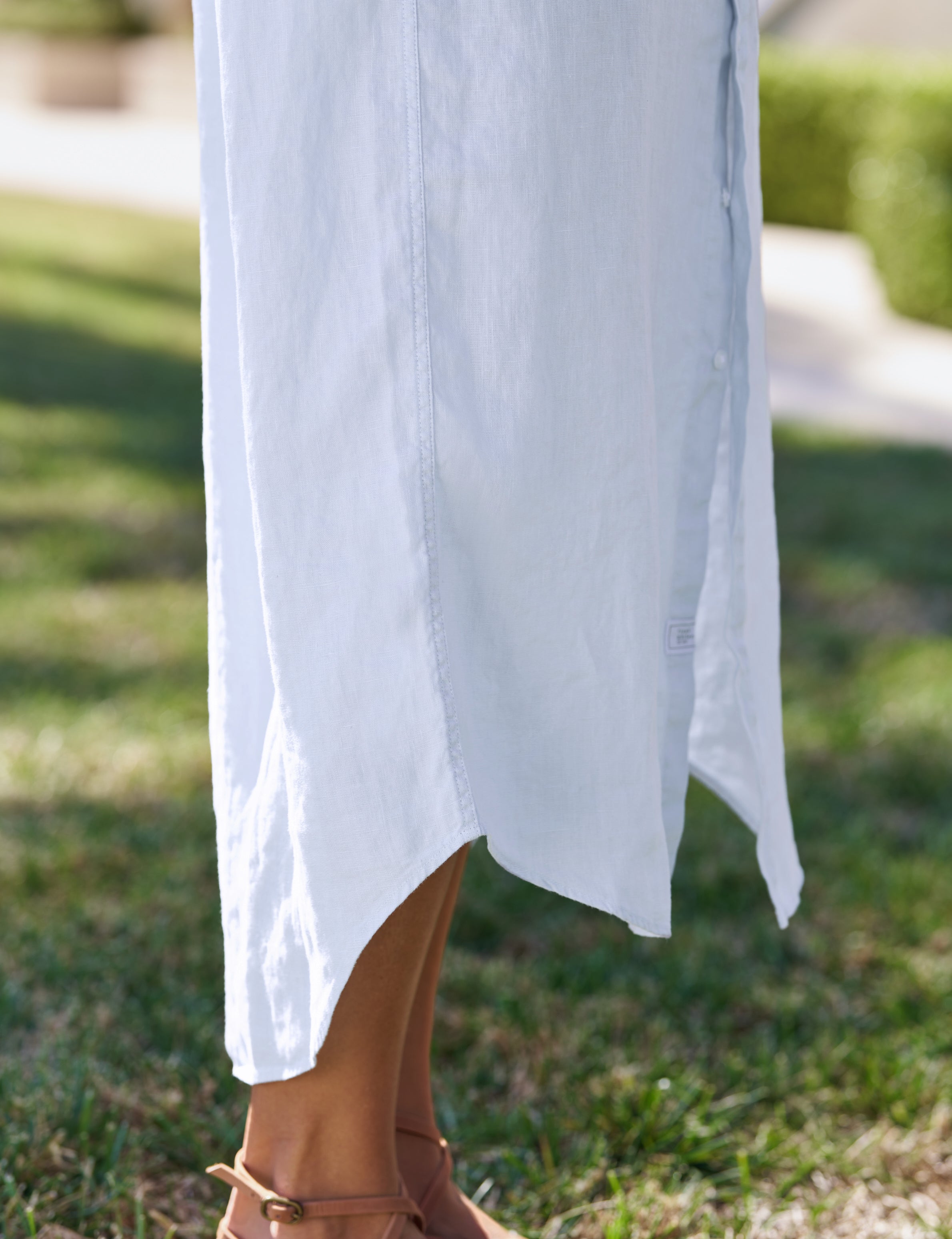 Blue dress with a blurred background of green grass, view 3