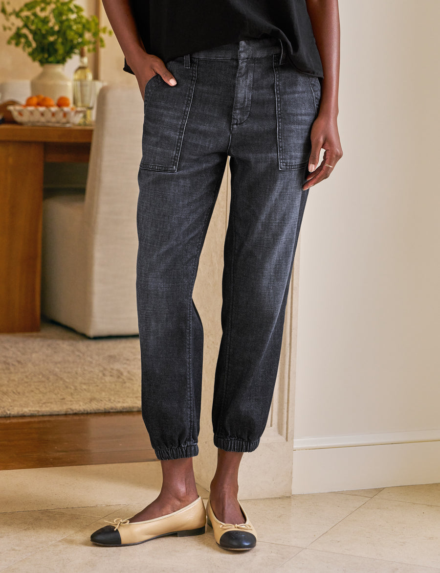 Person wearing dark jeans and flats in a home setting