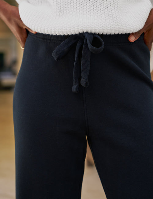 Navy pants with a drawstring waist worn by a person, with a blurred background., view 3