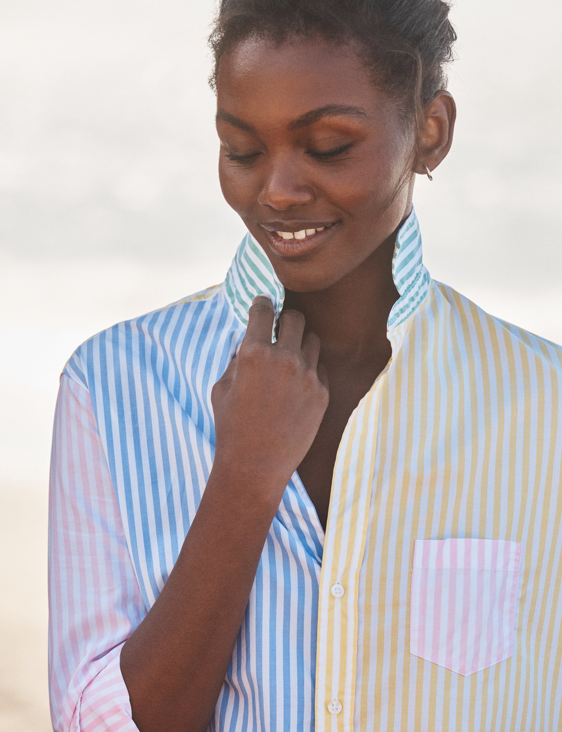 Woman wearing a striped shirt with a blurred background, view 3