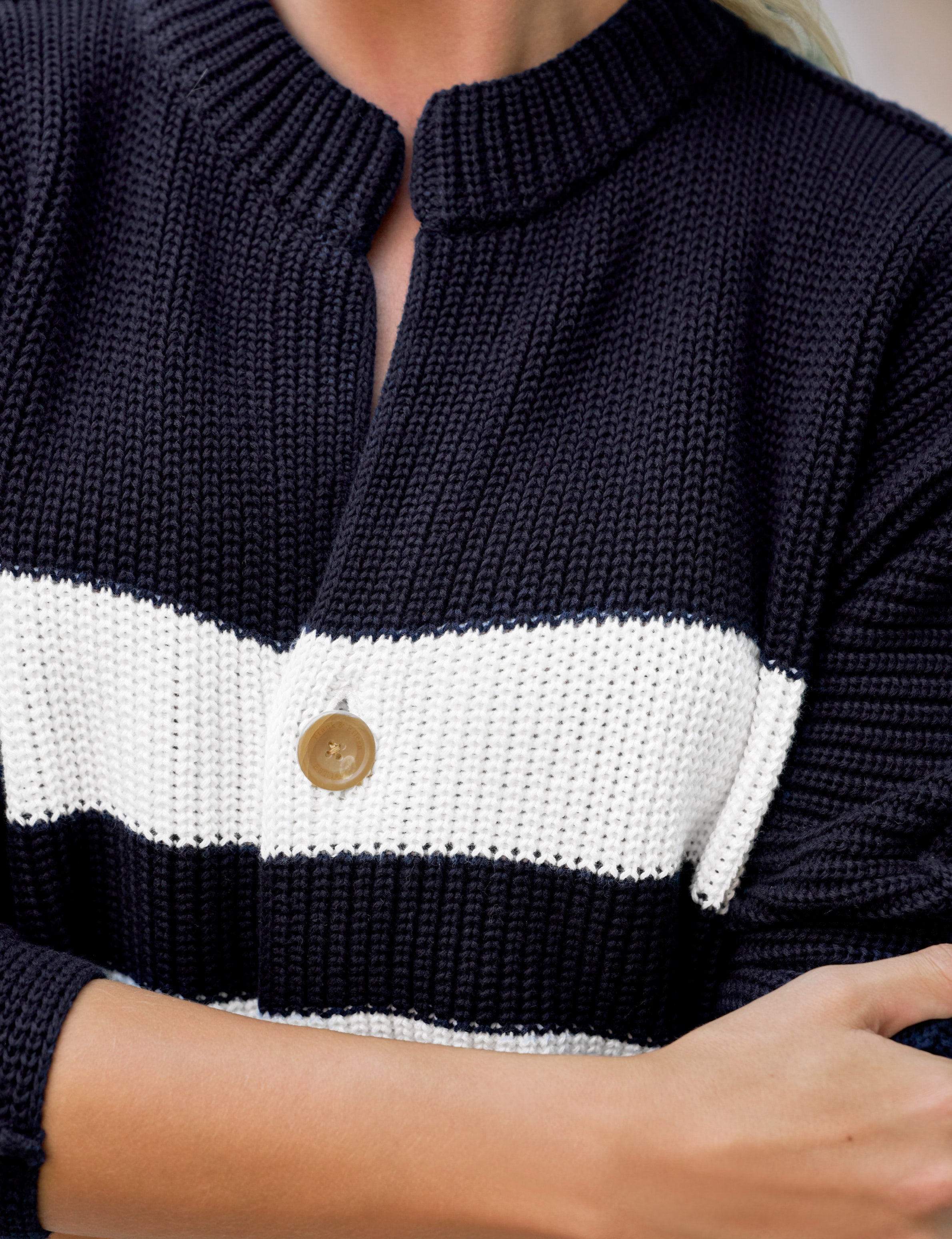 Navy and white striped sweater with a button detail