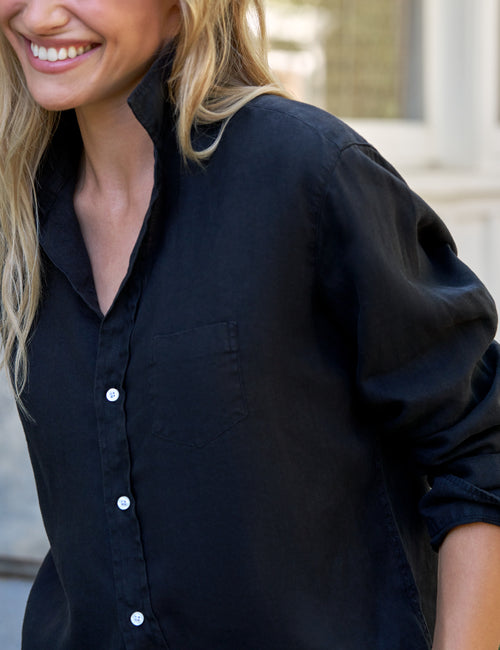 Woman wearing a black shirt with a blurred background, view 3