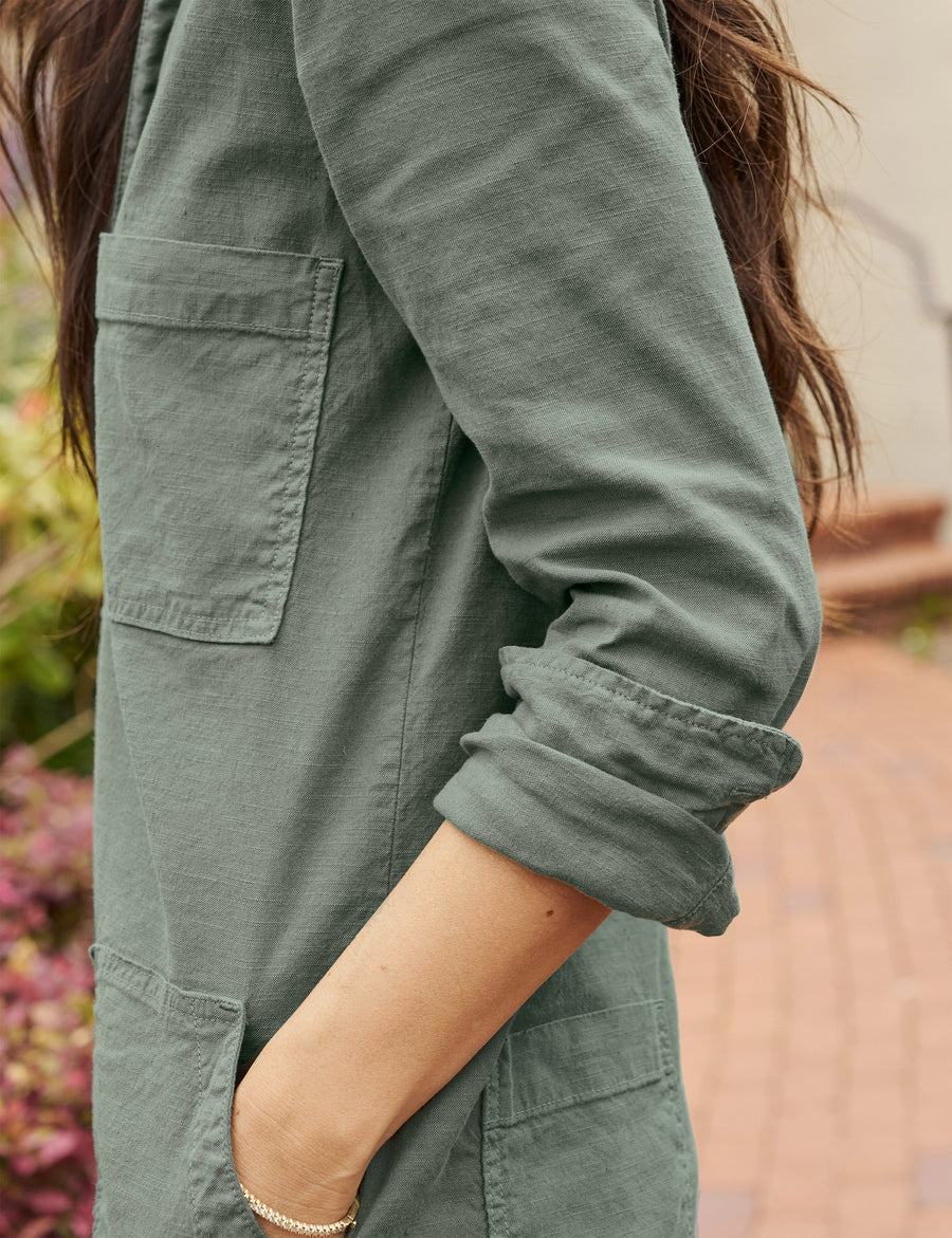 Detail of rolled up sleeve on person wearing Green Frank & Eileen Ireland Long-Sleeve Playsuit in Italian Performance Linen