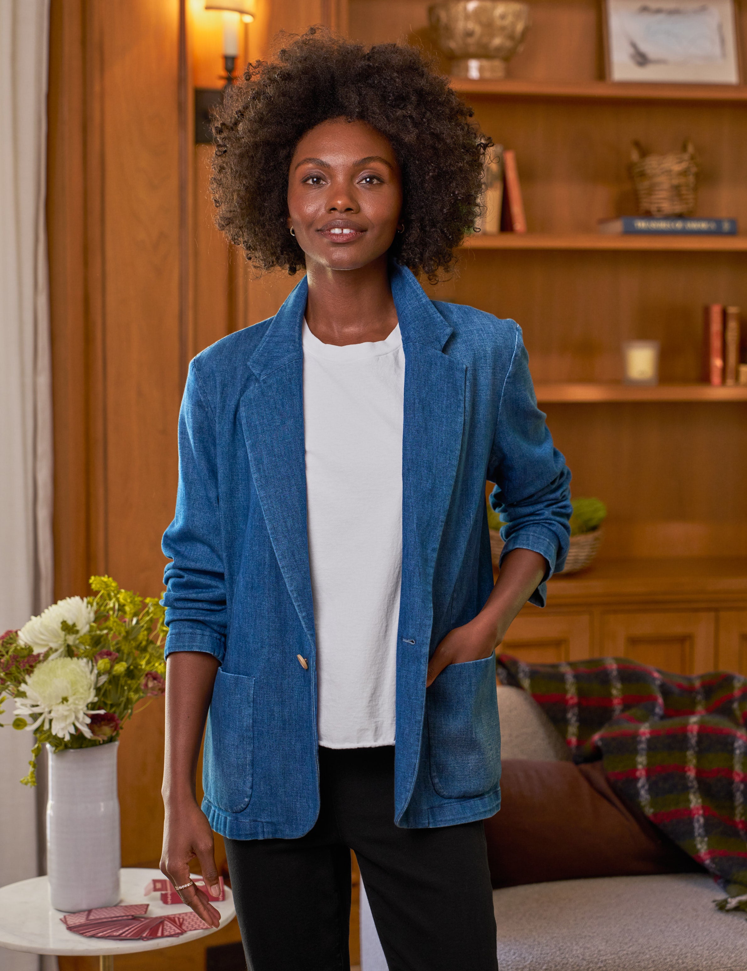 Woman wearing a blue blazer in a cozy living room setting