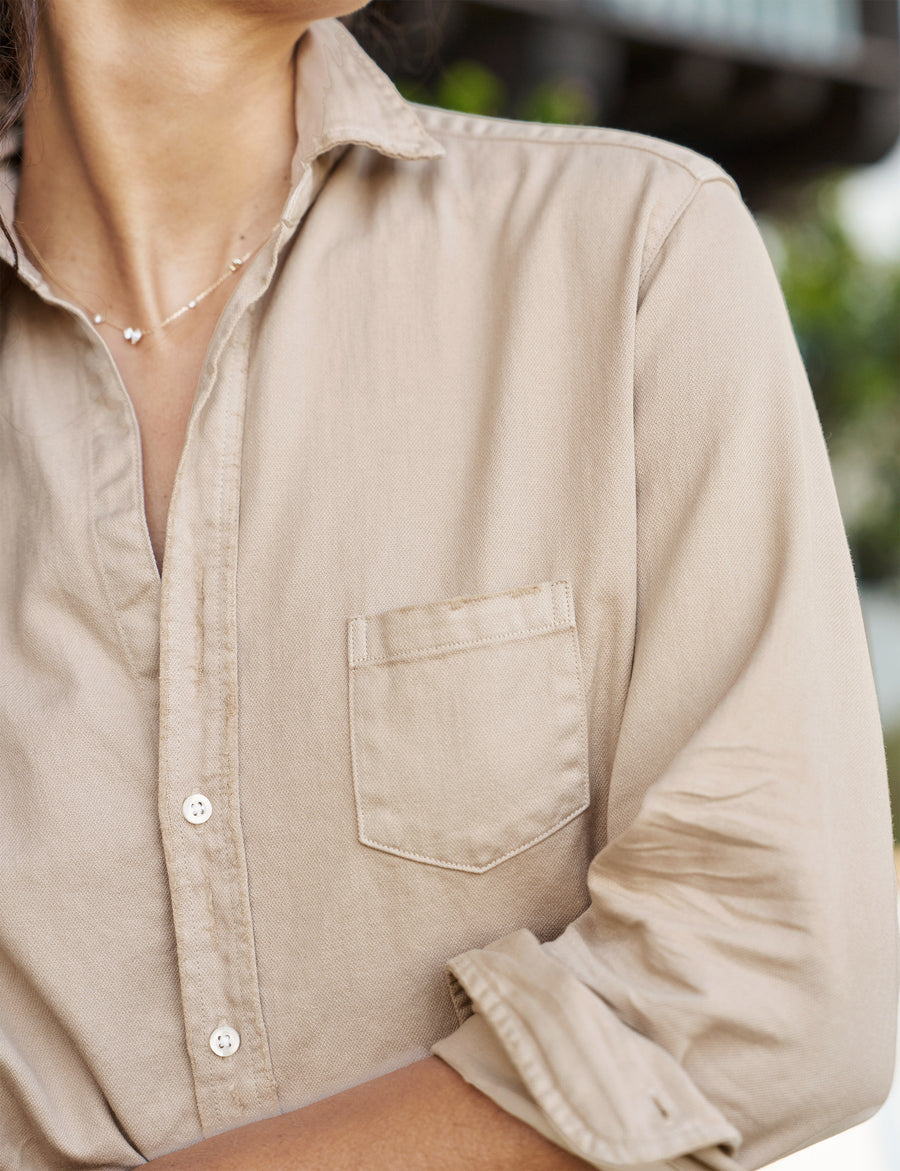 Detail of front button placket and pocket on person wearing Tan Frank & Eileen Eileen Relaxed Button-Up Shirt in Famous Denim