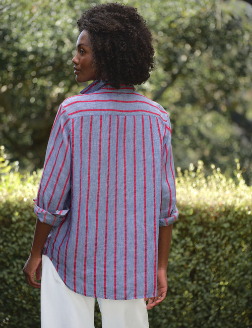 Woman wearing a blue and red striped shirt in an outdoor setting, alternate view