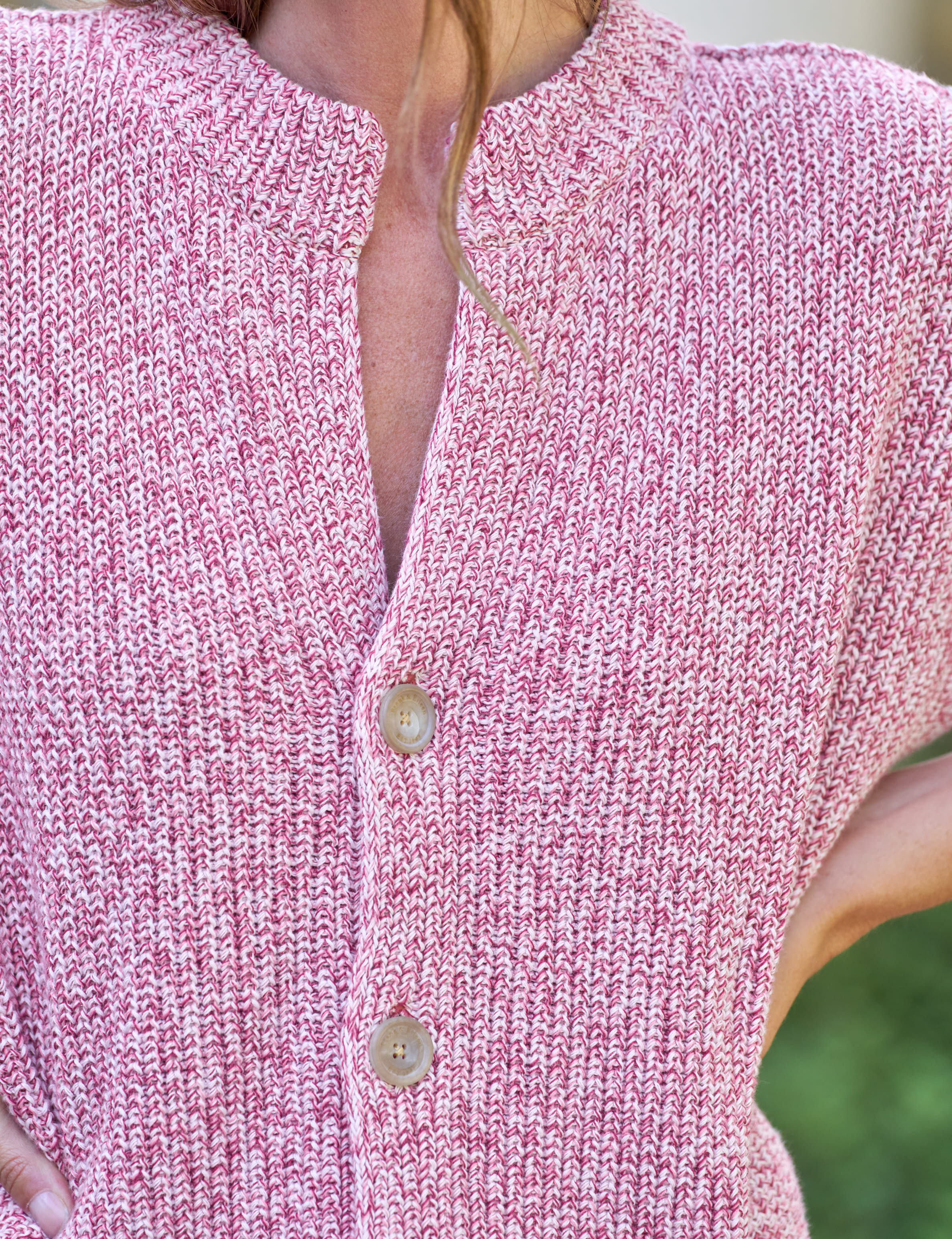Close-up of a pink knitted cardigan with buttons., view 3