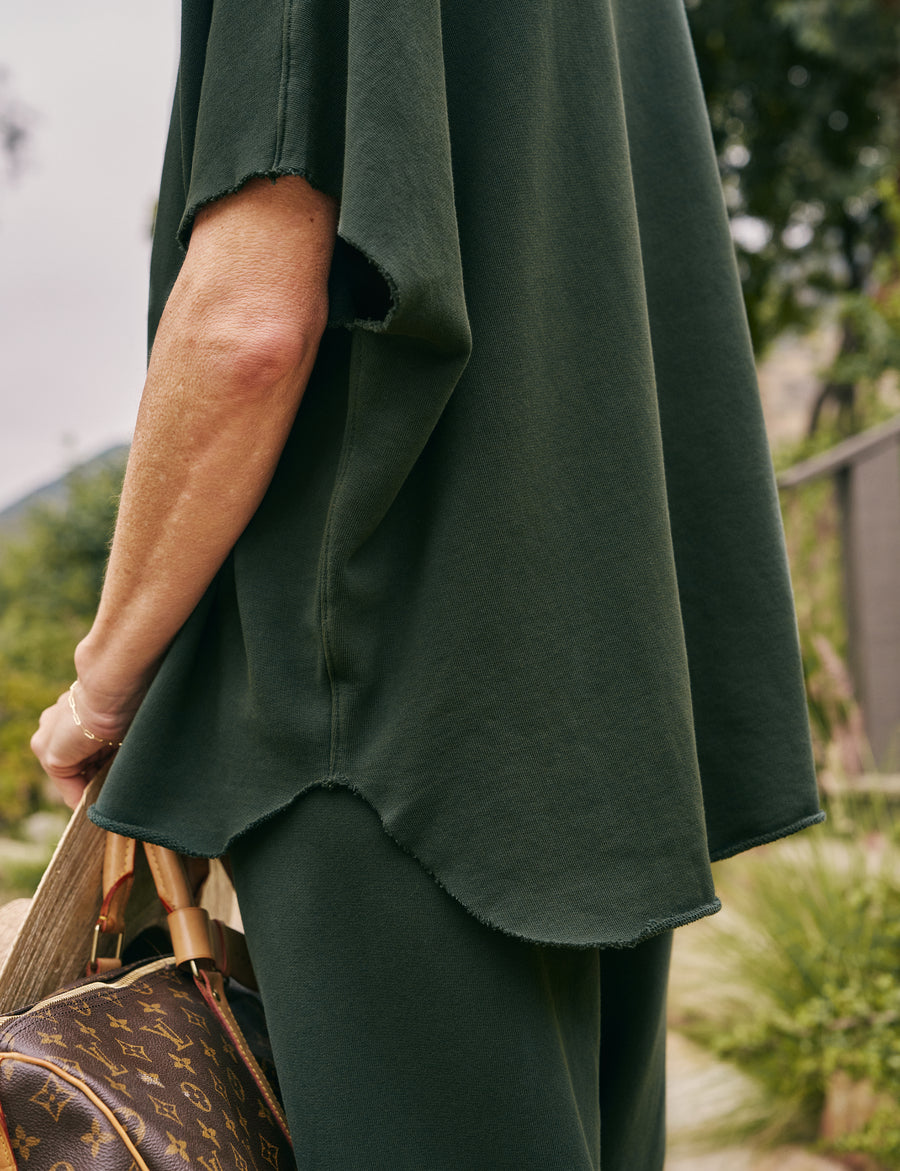 Detail of curved hem on person wearing Green Frank & Eileen Malibu Travel Set Audrey Capelet and Catherine Sweatpant in Triple Fleece