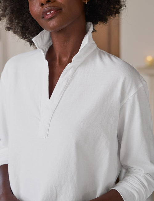 Woman wearing a white shirt with a blurred background, view 3