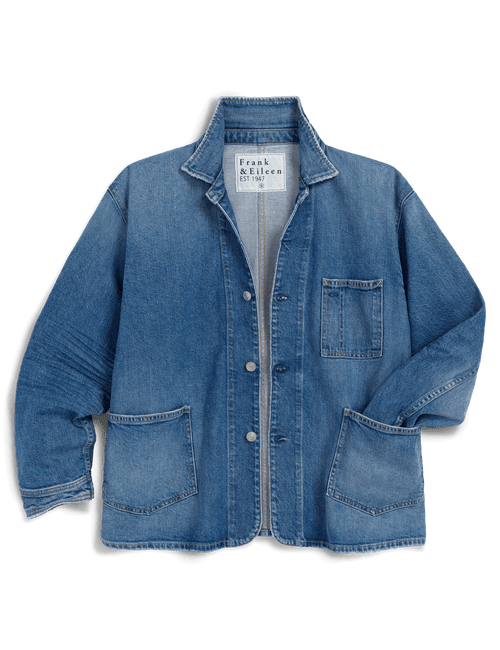 A blue denim work jacket by Frank & Eileen, featuring a button-up front, pointed collar, chest pocket, and two large front patch pockets, shown against a solid black background., view 7