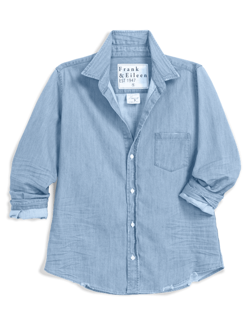 A light blue chambray button-up shirt by Frank & Eileen, featuring a chest pocket and rolled-up sleeves, shown against a solid green background., view 4