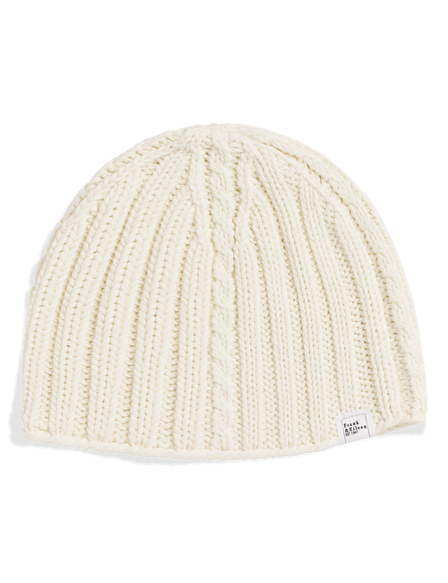 An off-white cable-knit beanie hat with a small white brand tag on the side, photographed on a clean white background., view 3
