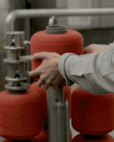 Rotating short videos of yarn in a factory.