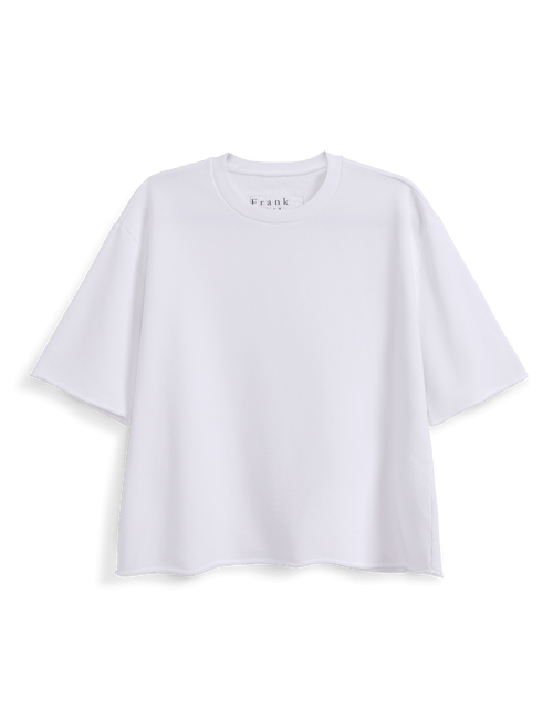 A white short-sleeve crewneck t-shirt with a relaxed, oversized fit, displayed against a solid black background. The brand name is printed in small black letters inside the collar., view 4
