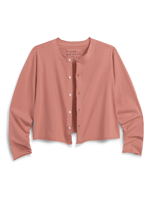 Orange long-sleeve shirt with buttons on a black background, front view