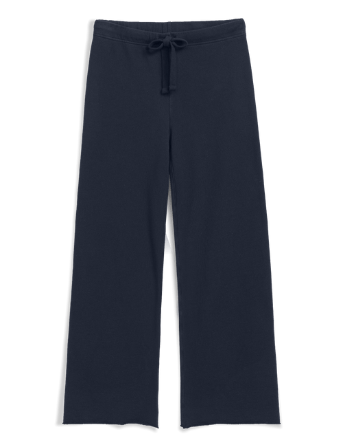 A pair of dark navy wide-leg pants with an elastic waistband and a matching drawstring, shown against a solid black background., view 4