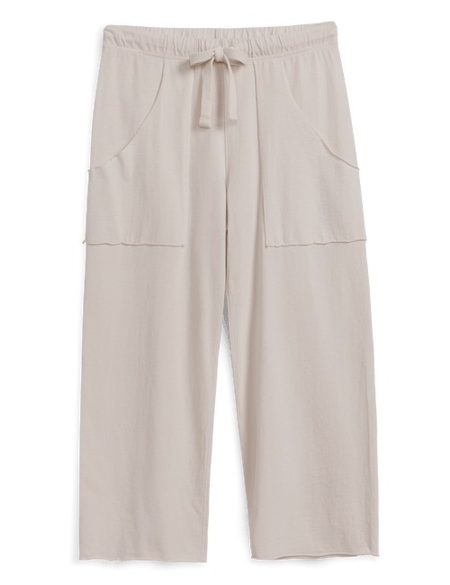 Beige pants with drawstring waist on a black background, front view
