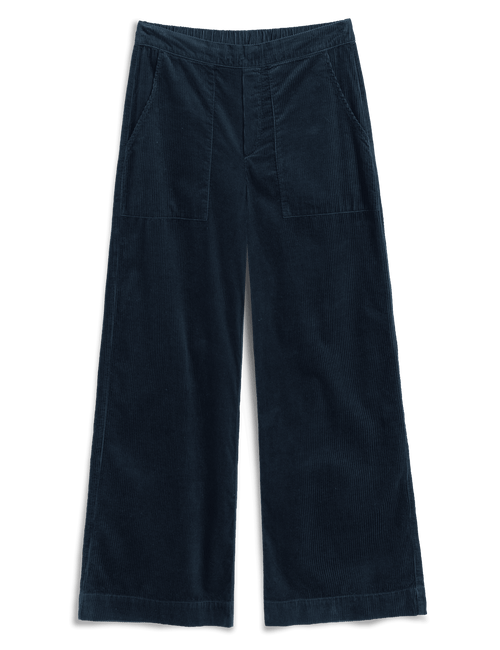 A pair of dark navy blue corduroy trousers with a wide leg, featuring a button fly, elastic waistband, and two large patch pockets on the back, shown flat on a white background., view 4