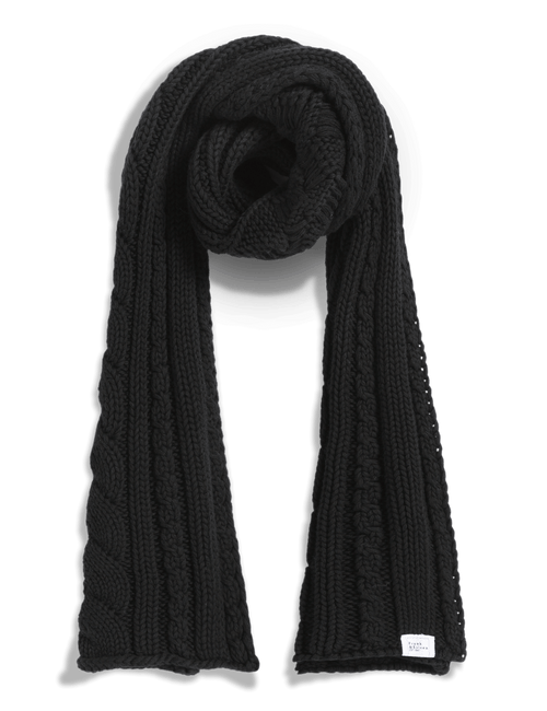 A black cable-knit scarf with a twisted center and a small white brand tag near the bottom right, displayed on a clean white background., front view