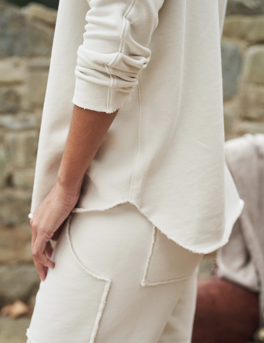 Waist of person wearing Vintage White Frank & Eileen Effie Long-Sleeve Funnel Neck Capelet in Triple Fleece