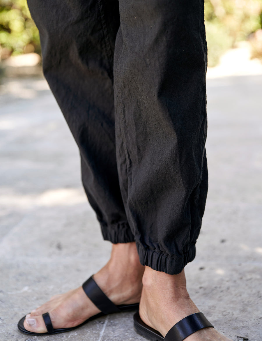 Detail shot of cinched bottom hem on person wearing Black Frank & Eileen Jameson Utility Jogger in Italian Performance Linen
