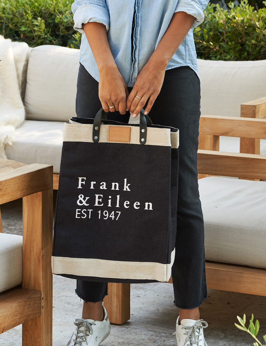 Person stands holding Black and Cream Frank & Eileen Market Tote in Natural Jute